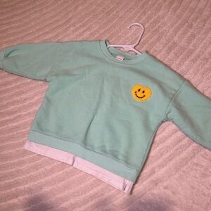 green sweatshirt with heart smiley 💛😊